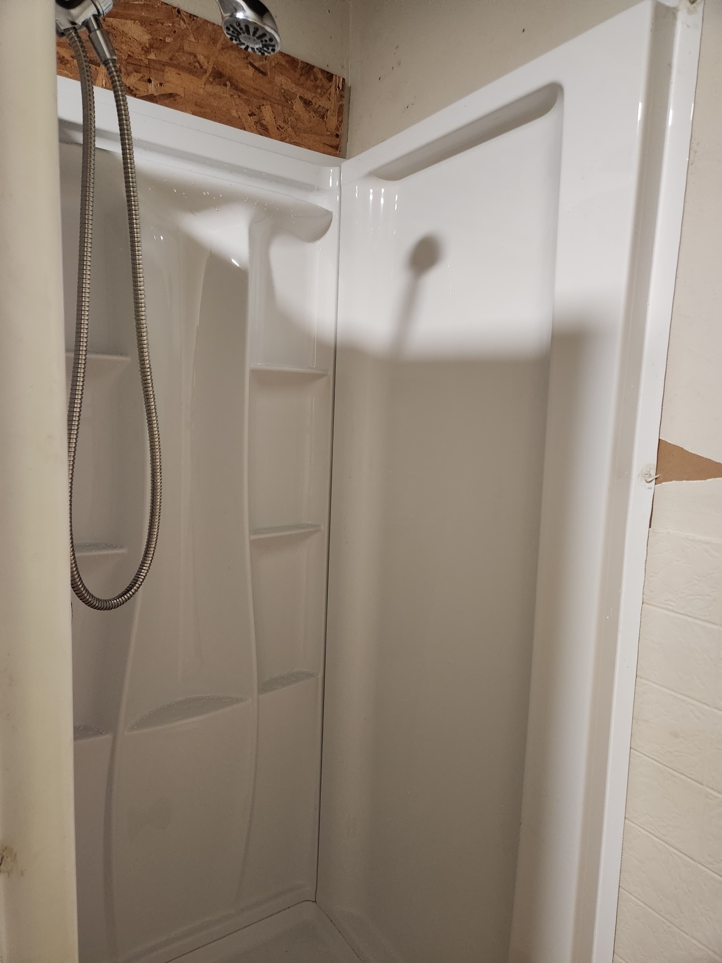 Complete shower installation with new surround, showerhead and handheld sprayer
