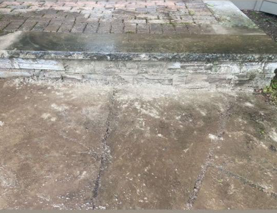 Restored stone foundation and clean paver surface after repair