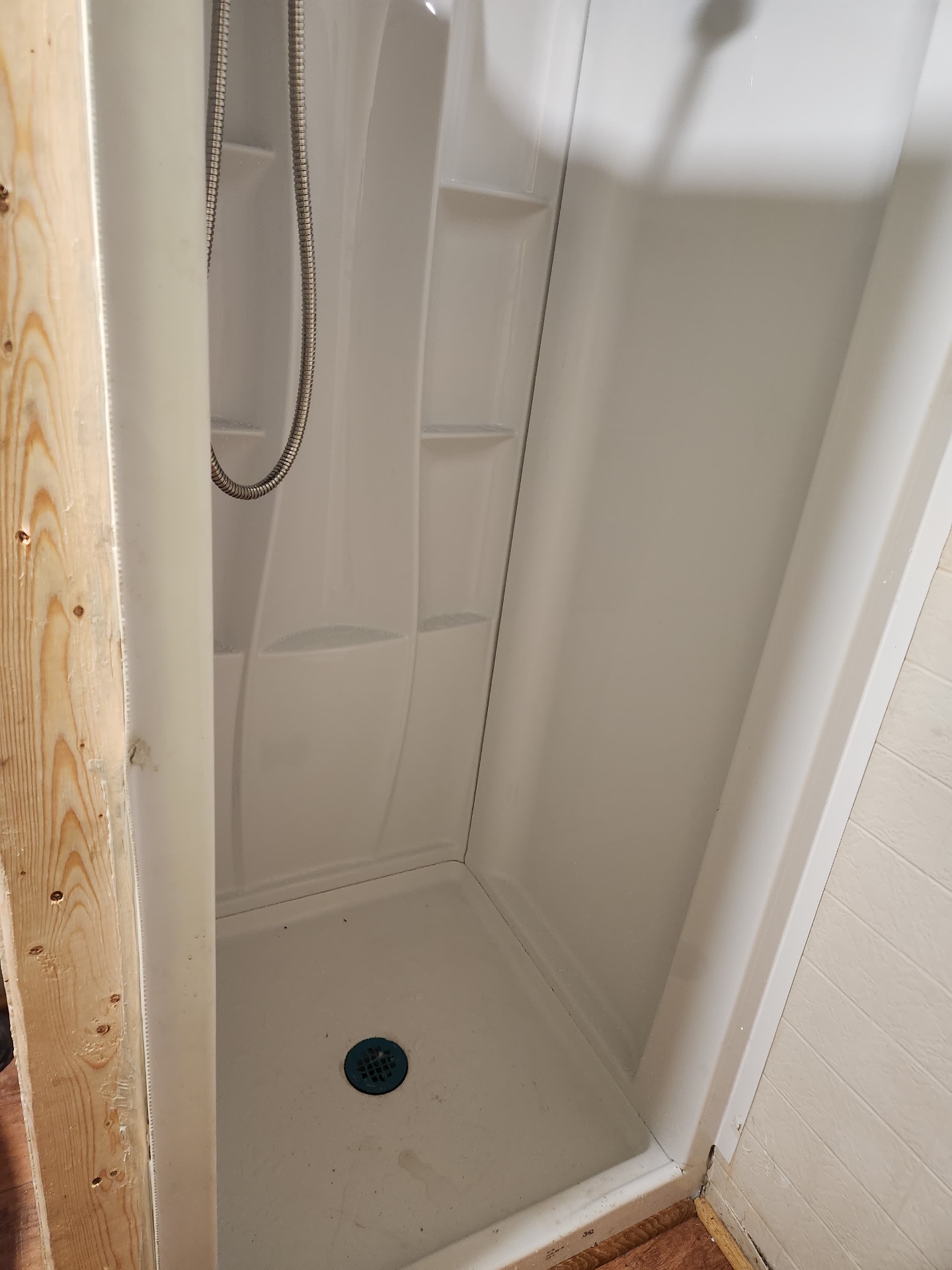 New white shower stall with replaced pan and drain